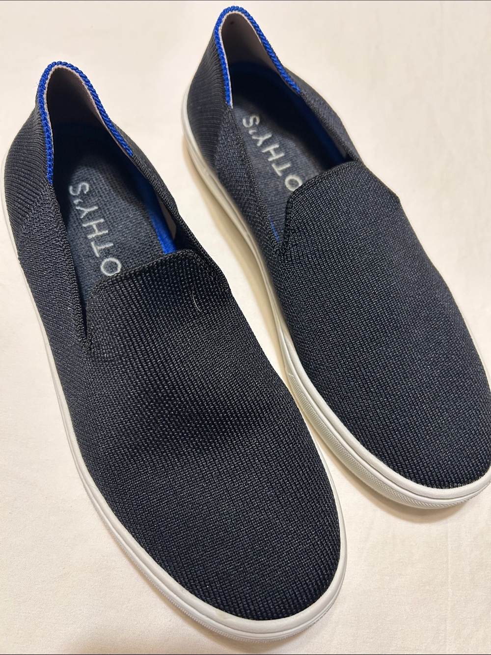 Rothy's Women’s Slip-On Knit Sneakers in Black with Blue Trim